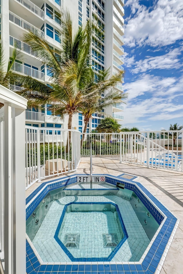 view of pool with a community hot tub