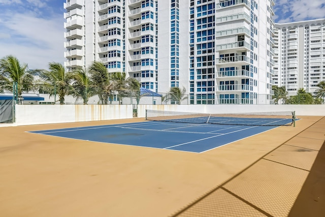 view of tennis court featuring fence