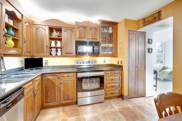 kitchen with open shelves, stainless steel appliances, brown cabinets, and a sink