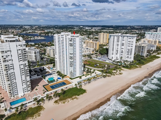 birds eye view of property with a water view, a city view, and a view of the beach