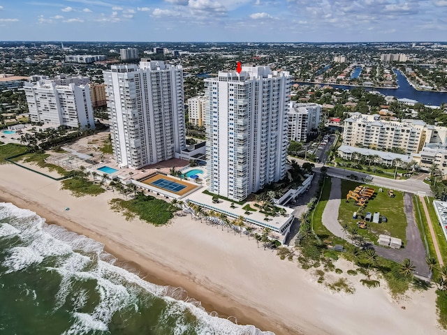 drone / aerial view featuring a city view, a beach view, and a water view