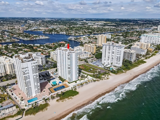 birds eye view of property featuring a water view, a city view, and a view of the beach