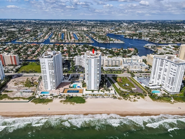 aerial view featuring a city view, a beach view, and a water view