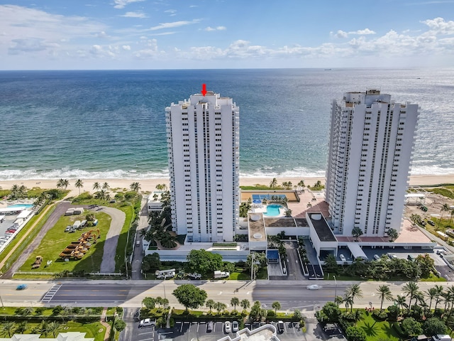 birds eye view of property with a beach view and a water view