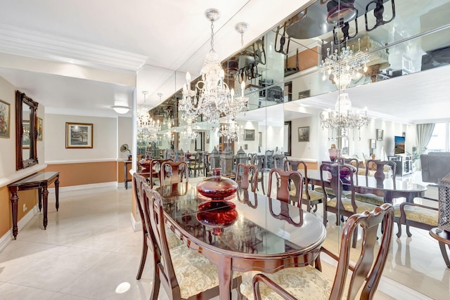 dining space with tile patterned floors, a chandelier, baseboards, and ornamental molding