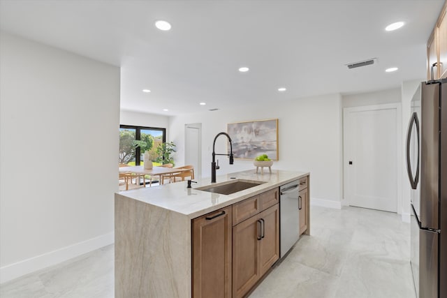 kitchen featuring visible vents, recessed lighting, a kitchen island with sink, a sink, and stainless steel appliances