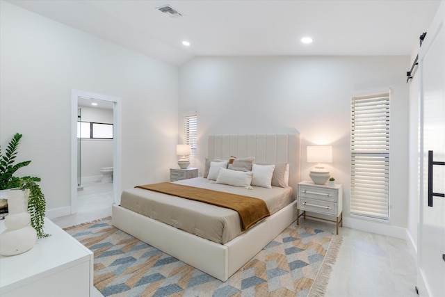 bedroom featuring visible vents, ensuite bath, lofted ceiling, recessed lighting, and a barn door