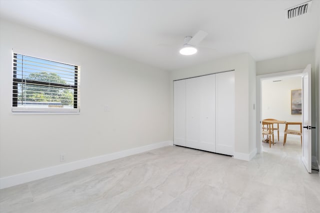 unfurnished bedroom featuring visible vents, baseboards, a closet, and ceiling fan