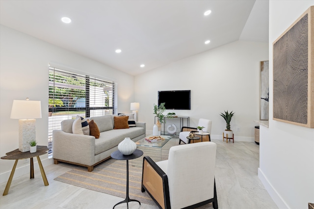 living area featuring recessed lighting, baseboards, and lofted ceiling