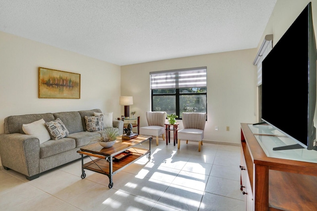 living area featuring light tile patterned floors and a textured ceiling