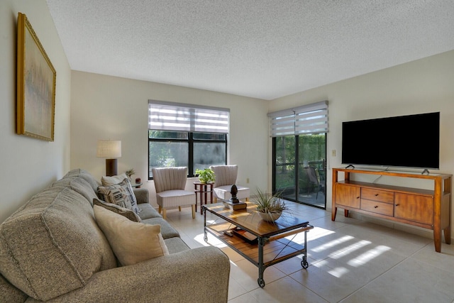 living area featuring light tile patterned flooring and a textured ceiling