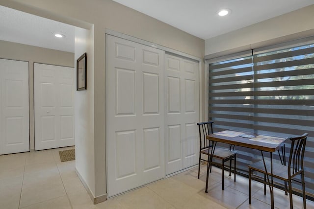 dining space with recessed lighting and light tile patterned flooring