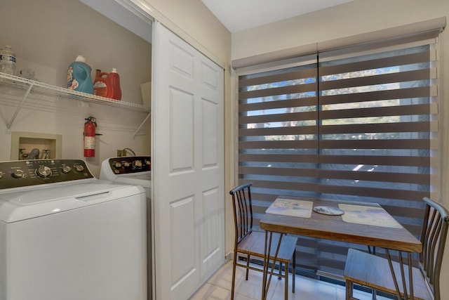 laundry room featuring laundry area, light tile patterned flooring, and independent washer and dryer