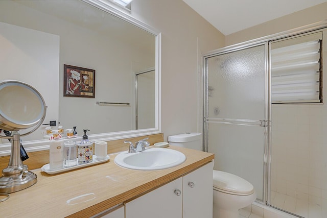 bathroom with a stall shower, toilet, and vanity