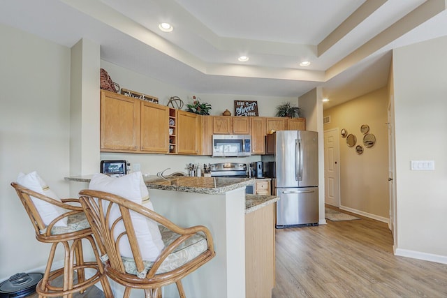 8290 Mulligan Cir Unit 2421, Port Saint Lucie, FL 34986 - kitchen featuring appliances with stainless steel finishes, recessed lighting, open shelves, a peninsula, and light wood-style flooring