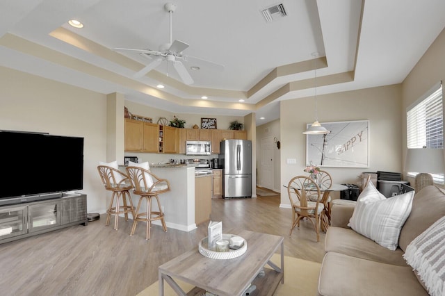8290 Mulligan Cir Unit 2421, Port Saint Lucie, FL 34986 - living room featuring a tray ceiling, ceiling fan, light wood finished floors, recessed lighting, and baseboards