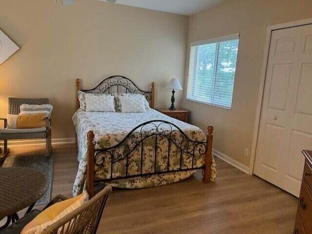 8290 Mulligan Cir Unit 2421, Port Saint Lucie, FL 34986 - bedroom featuring wood finished floors and baseboards