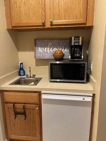 8290 Mulligan Cir Unit 2421, Port Saint Lucie, FL 34986 - bar area with white dishwasher and a sink