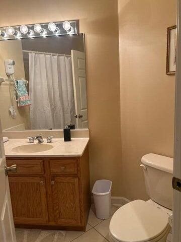 8290 Mulligan Cir Unit 2421, Port Saint Lucie, FL 34986 - bathroom with toilet, vanity, a shower with shower curtain, and tile patterned flooring