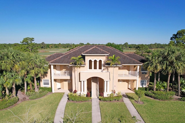8290 Mulligan Cir Unit 2421, Port Saint Lucie, FL 34986 - mediterranean / spanish house with a balcony, a front yard, stucco siding, and a tile roof