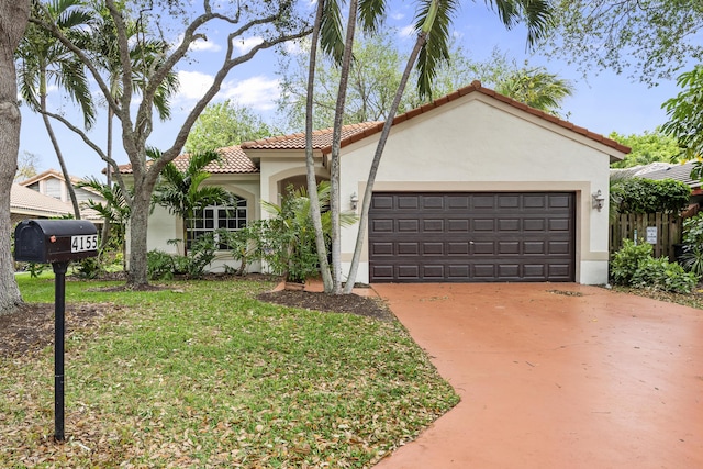 mediterranean / spanish-style house featuring stucco siding, driveway, a tile roof, and a front lawn