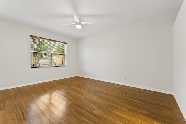 unfurnished room with ceiling fan, baseboards, and wood finished floors