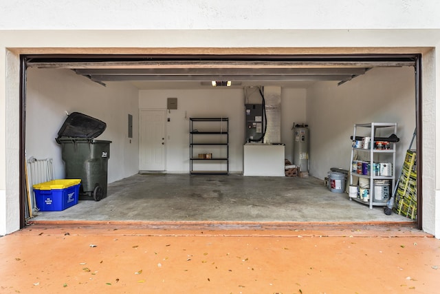 garage with electric panel, heating unit, and electric water heater