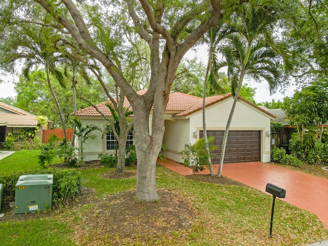 view of front of house featuring fence, stucco siding, concrete driveway, a garage, and a tiled roof