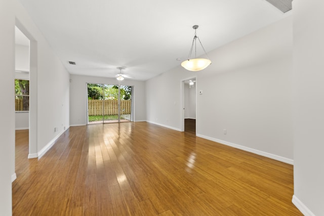 spare room featuring visible vents, baseboards, light wood finished floors, and ceiling fan