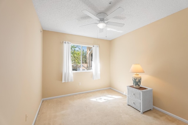 empty room featuring baseboards, carpet floors, and ceiling fan