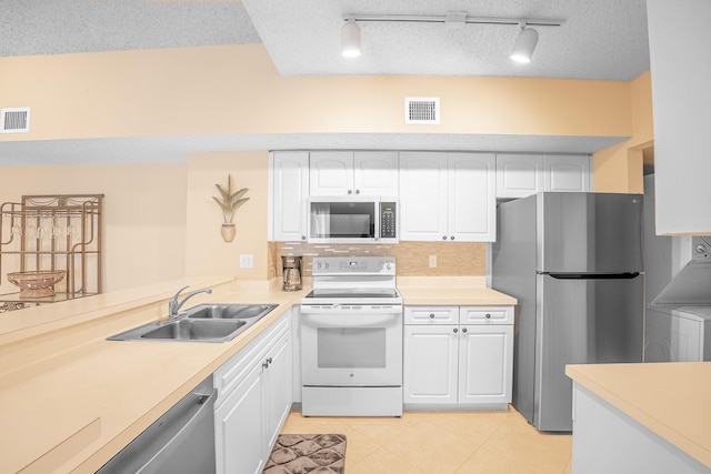 kitchen featuring visible vents, light countertops, appliances with stainless steel finishes, white cabinetry, and a sink