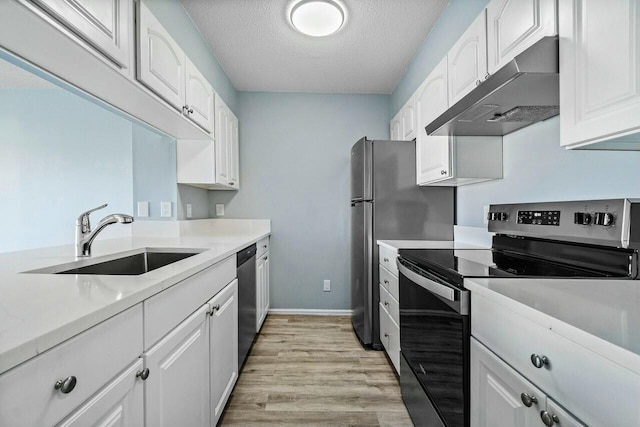 kitchen featuring under cabinet range hood, light countertops, stainless steel appliances, white cabinetry, and a sink