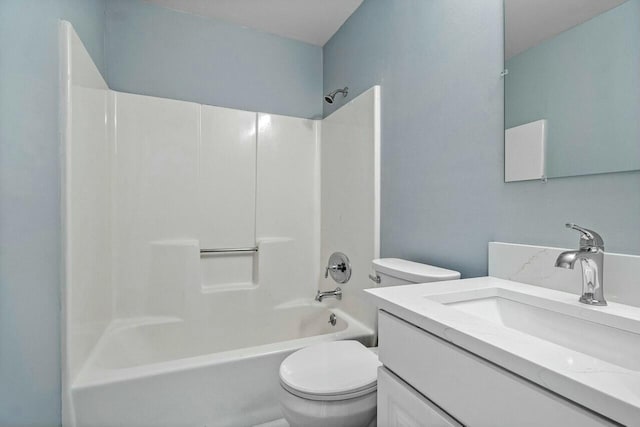 full bathroom featuring toilet, vanity, and  shower combination