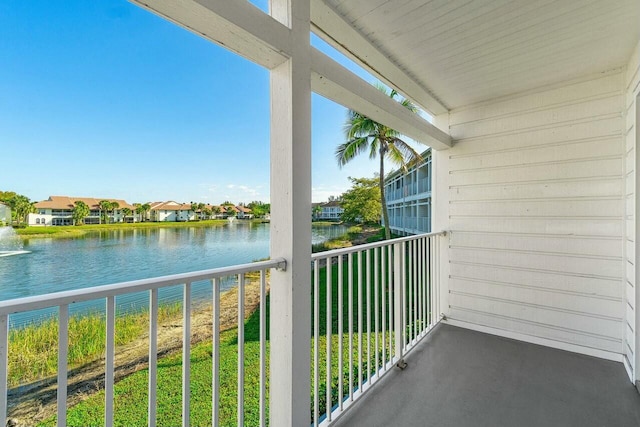 balcony with a water view and a residential view