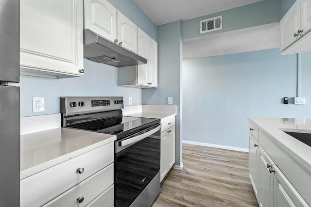 kitchen with white cabinetry, electric range, visible vents, and under cabinet range hood