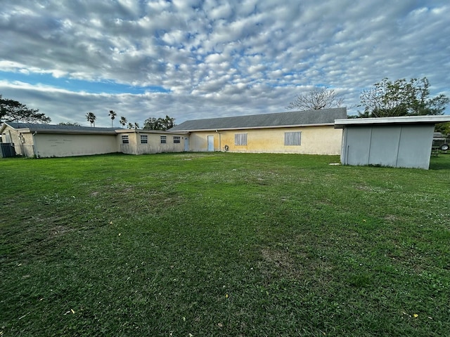 rear view of house featuring a yard