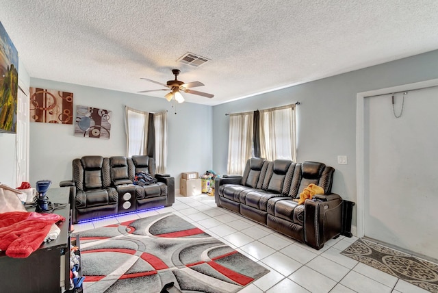 living area featuring visible vents, a textured ceiling, ceiling fan, and light tile patterned flooring