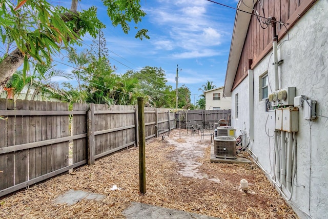 view of yard with cooling unit and a fenced backyard