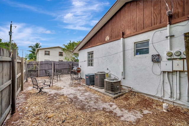 exterior space with cooling unit and a fenced backyard