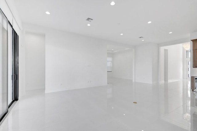 spare room featuring recessed lighting and visible vents