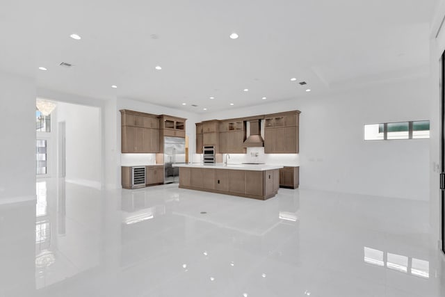 kitchen featuring visible vents, recessed lighting, stainless steel appliances, wall chimney exhaust hood, and light countertops