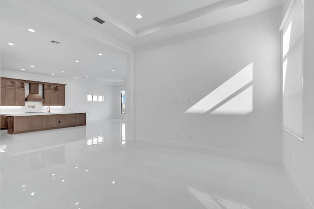 unfurnished living room featuring recessed lighting, visible vents, and baseboards