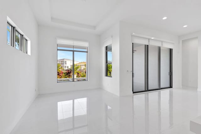 empty room with a tray ceiling and recessed lighting