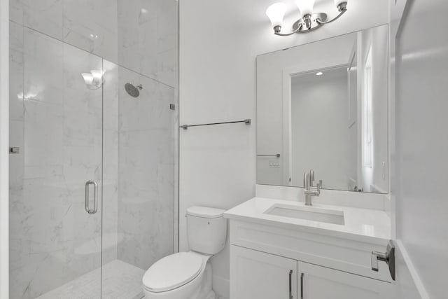 bathroom featuring vanity, toilet, and a marble finish shower