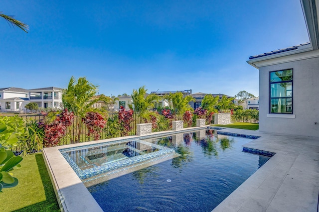 view of pool with a patio, a fenced backyard, a residential view, and a pool with connected hot tub