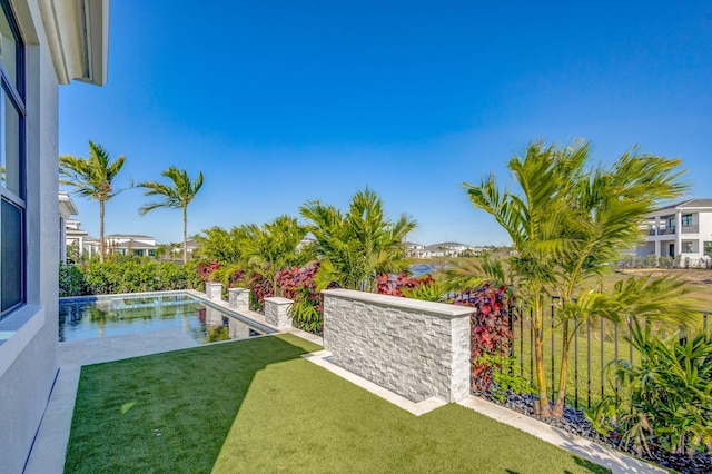 view of yard featuring a patio area, an outdoor pool, and fence