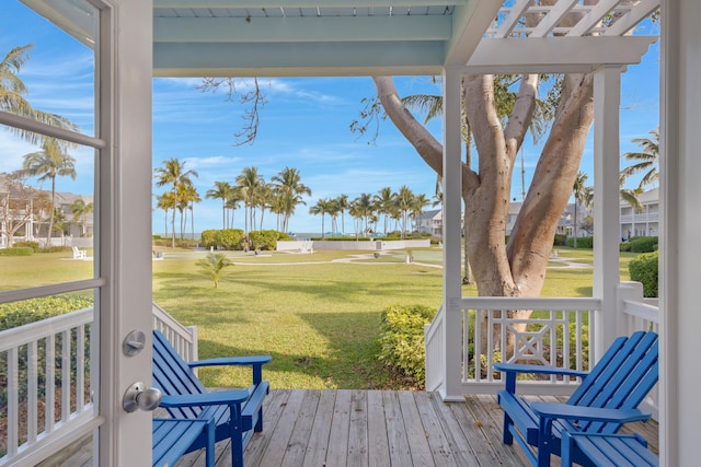 wooden deck with a porch and a yard