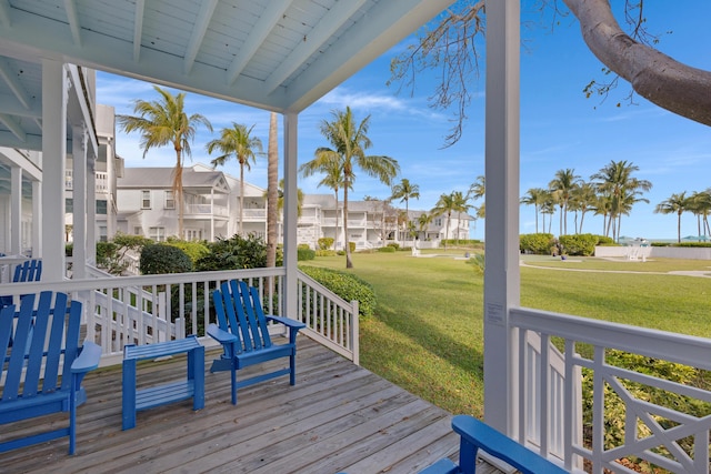 deck with a residential view and a lawn