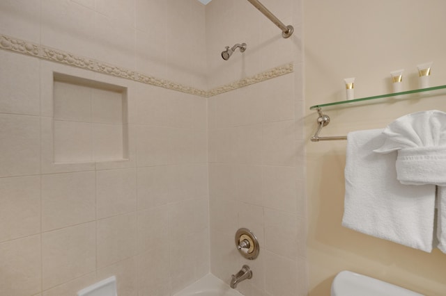 bathroom featuring tub / shower combination and toilet