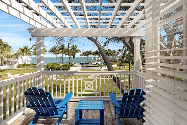 wooden deck featuring a water view and a pergola